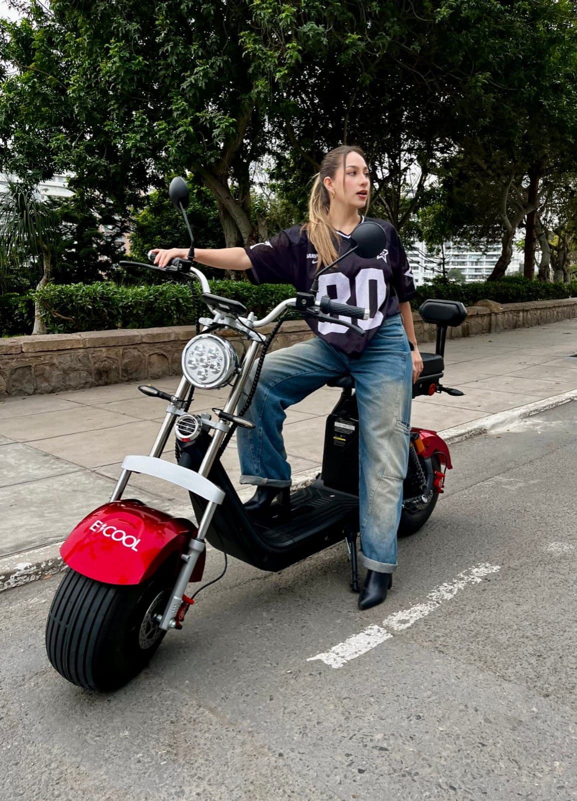 Modelo ECOOL Chopper Full 1500W rojo con mujer en un parque urbano