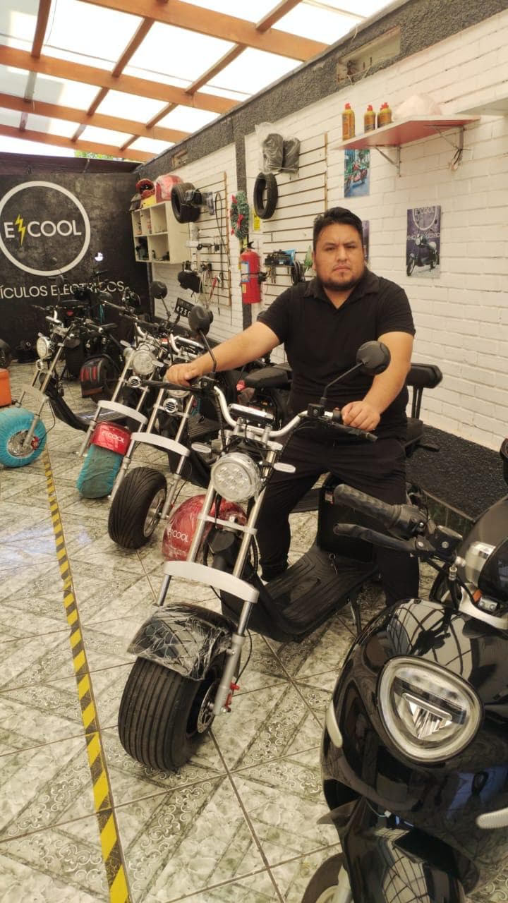 Cliente feliz en su ECOOL chopper negra en el showroom